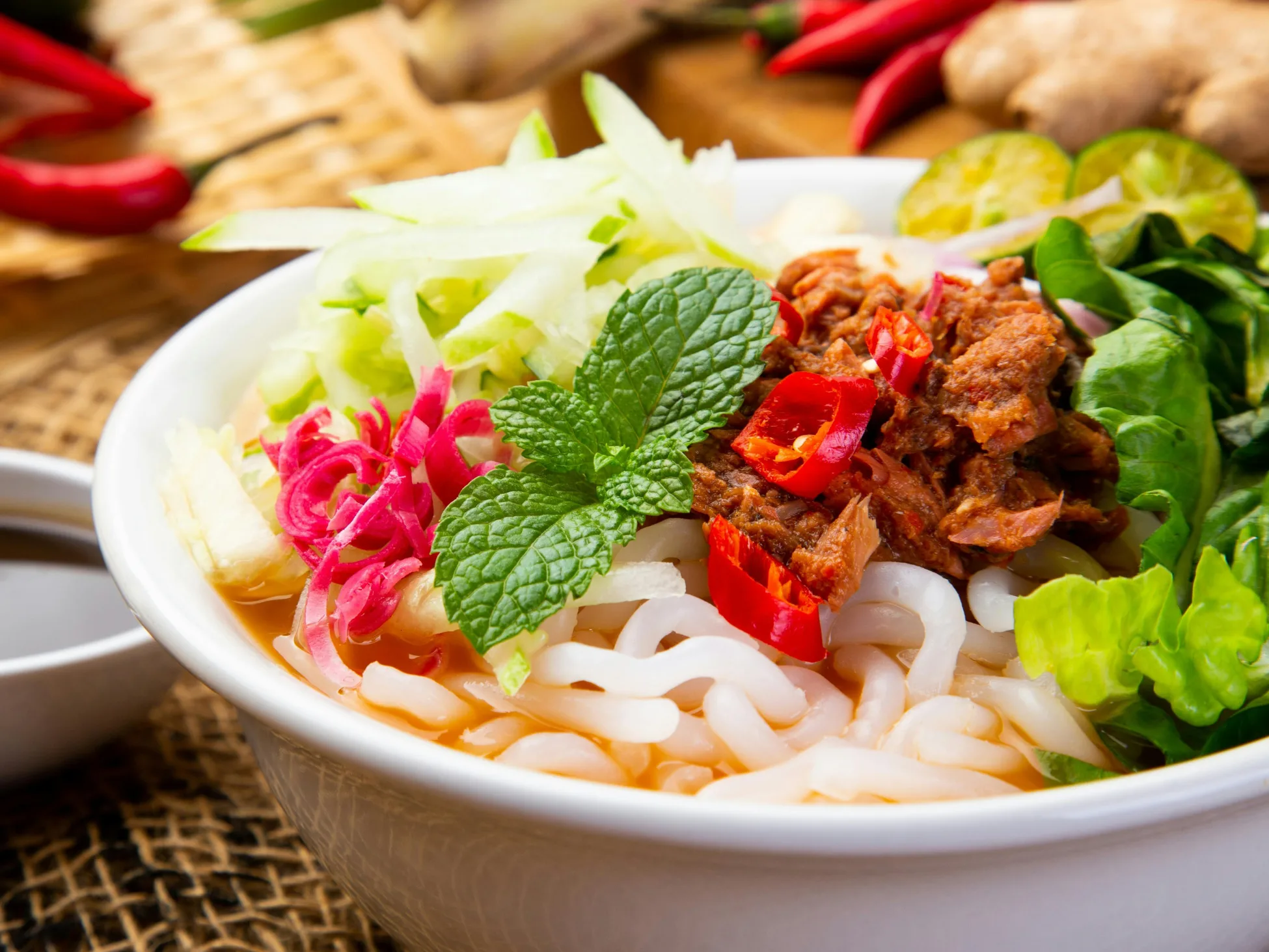 Signature noodle bowl with rice noodles, fresh mint, chili and herbs